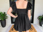 woman wearing black bubble dress close shot